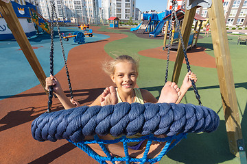 Image showing Girls ride a big round hanging swing