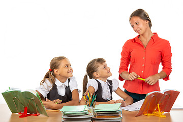 Image showing Girls at their desks have fun watching their beloved teacher