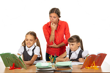 Image showing The student asked the teacher a question, the teacher looks at the book in disbelief