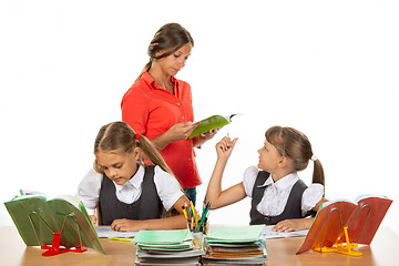 Image showing The teacher helps the schoolgirl to understand the task
