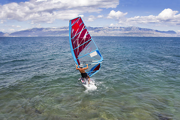 Image showing Young windsurfer in the waves in the sea