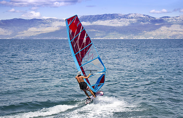 Image showing Young windsurfer in the waves in the sea