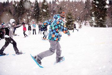 Image showing group of young people having a running competition on winter day