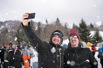 Image showing group of young people taking selfie in beautiful winter landscap