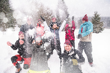 Image showing group of young people throwing snow in the air