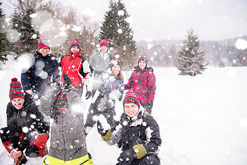 Image showing group of young people throwing snow in the air