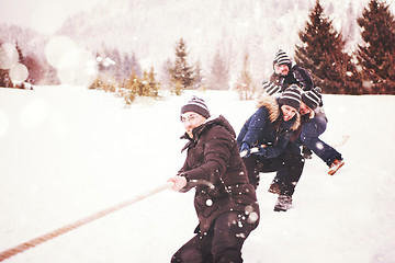 Image showing group of young people pulling a rope in tug of war competition