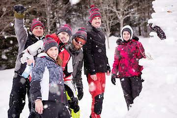 Image showing group portait of young people posing with snowman