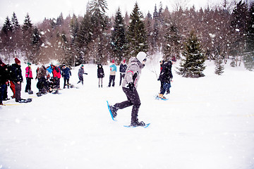 Image showing group of young people having a running competition on winter day