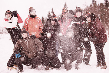 Image showing group of young people throwing snow in the air