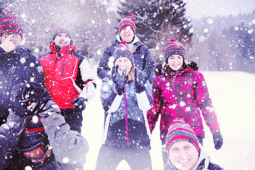 Image showing group of young people throwing snow in the air