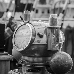 Image showing Reflection of a mast in an old ship compass, closeup. Black and white photo