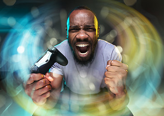 Image showing Enthusiastic gamer. Joyful young man holding a video game controller