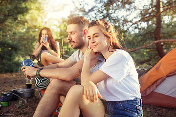 Image showing Party, camping of men and women group at forest. They relaxing