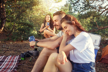 Image showing Party, camping of men and women group at forest. They relaxing