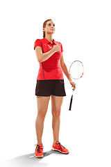 Image showing Young woman badminton player standing over white background