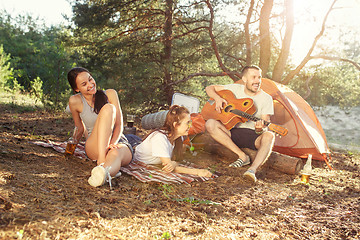 Image showing Party, camping of men and women group at forest. They relaxing, singing a song