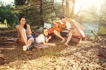 Image showing Party, camping of men and women group at forest. They relaxing, singing a song