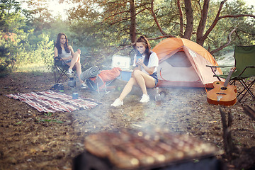 Image showing Party, camping of men and women group at forest. They relaxing, singing a song and cooking barbecue