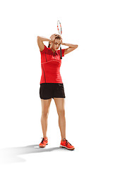 Image showing Young woman badminton player standing over white background