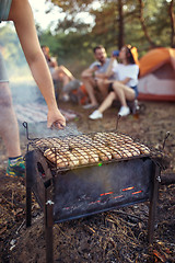 Image showing Party, camping of men and women group at forest. They relaxing, singing a song and cooking barbecue