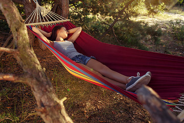 Image showing Party, camping. Woman sleeping at forest. She relaxing
