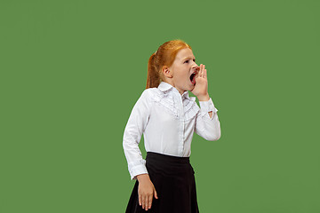 Image showing Isolated on green young casual teen girl shouting at studio