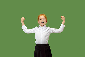 Image showing The happy teen girl standing and smiling against green background.