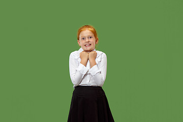 Image showing Beautiful teen girl looking suprised isolated on green