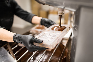 Image showing confectioner makes chocolate candies at sweet-shop