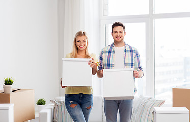 Image showing happy couple with boxes moving to new home