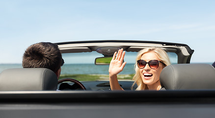 Image showing happy man and woman driving in cabriolet car