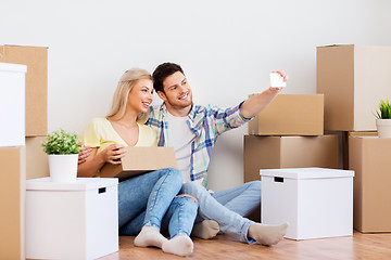 Image showing couple taking selfie and moving to new home
