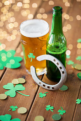 Image showing glass of beer, bottle, horseshoe and gold coins