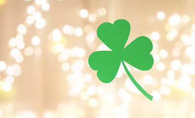 Image showing green paper shamrock over festive lights