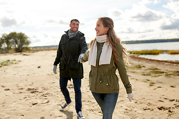 Image showing couple walking along autumn beach