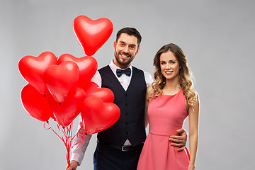 Image showing happy couple with red heart shaped balloons