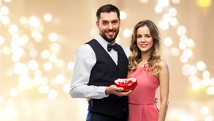 Image showing happy couple with chocolate box in shape of heart