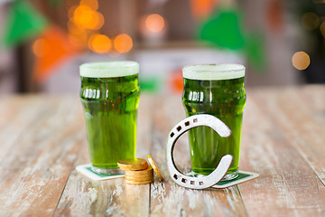 Image showing glasses of green beer, horseshoe and gold coins