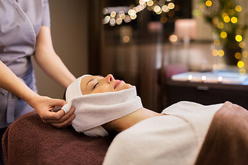 Image showing woman having face massage with towel at spa parlor