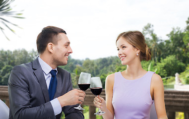 Image showing young couple with glasses of wine at restaurant