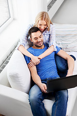 Image showing happy couple with laptop computer at home