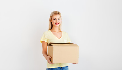 Image showing happy woman holding cardboard box