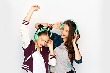 Image showing teenage girls in earphones listening to music