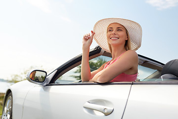 Image showing happy young woman in convertible car