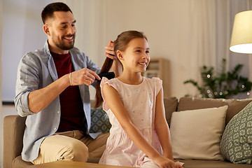 Image showing father brushing daughter hair at home