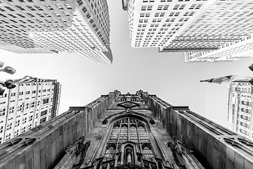 Image showing Wide angle upward view of Trinity Church at Broadway and Wall Street with surrounding skyscrapers, Lower Manhattan, New York City, USA