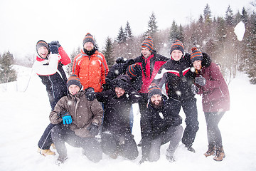 Image showing group of young people throwing snow in the air