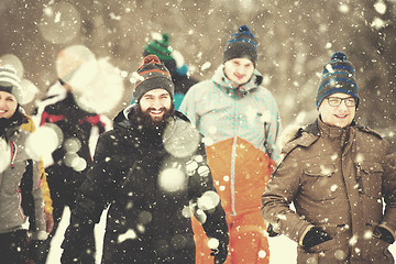 Image showing group of young people walking through beautiful winter landscape