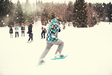 Image showing group of young people having a running competition on winter day